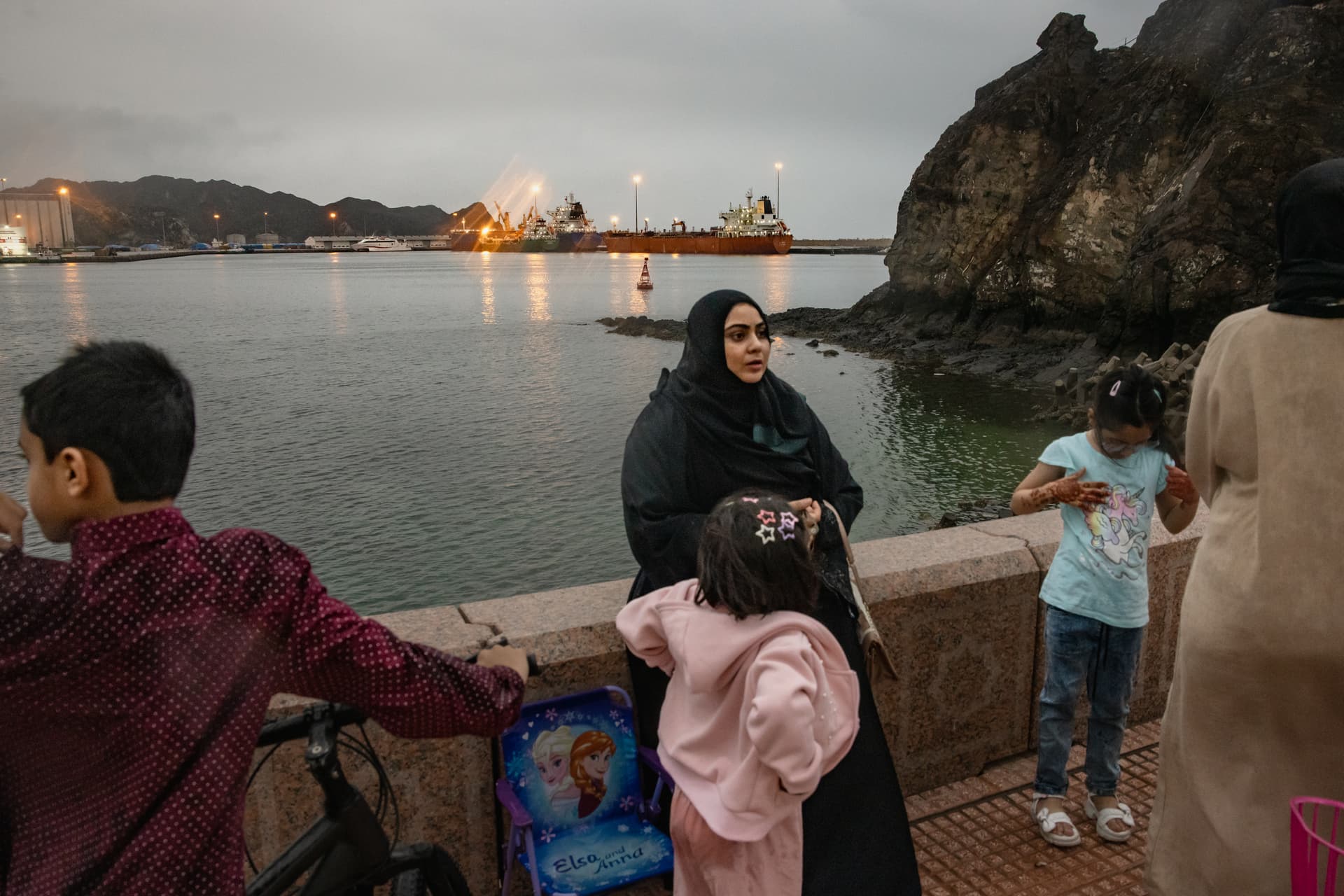 Elke Scholiers/Getty Images A bulk carrier sits anchored as families gather at Sultan Qaboos Port on March 23, 2026 in Muscat, Oman.