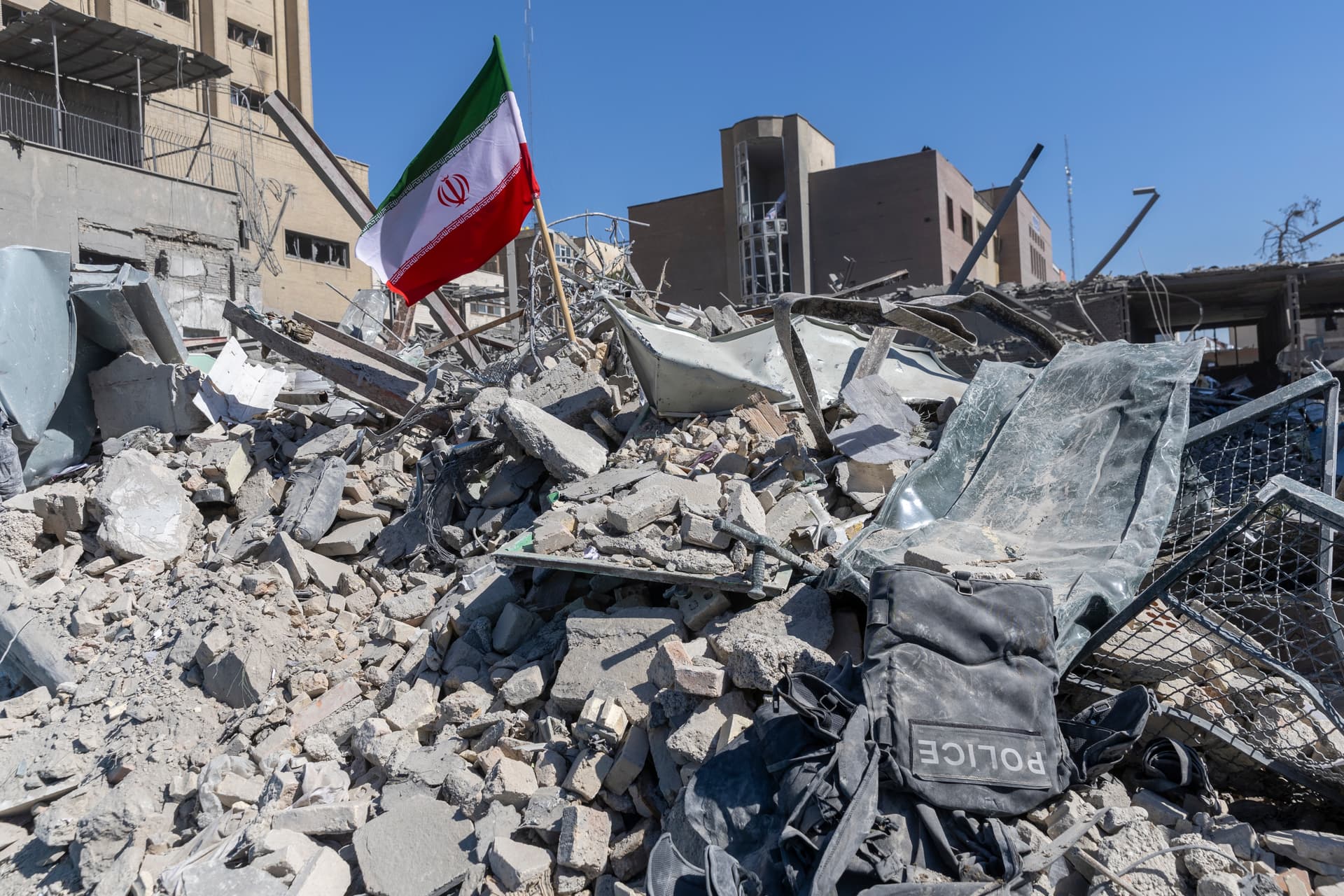 Majid Saeedi/Getty Images An Iranian flag is seen in the rubble of a police station at Tehran, Iran, on March 3, 2026.