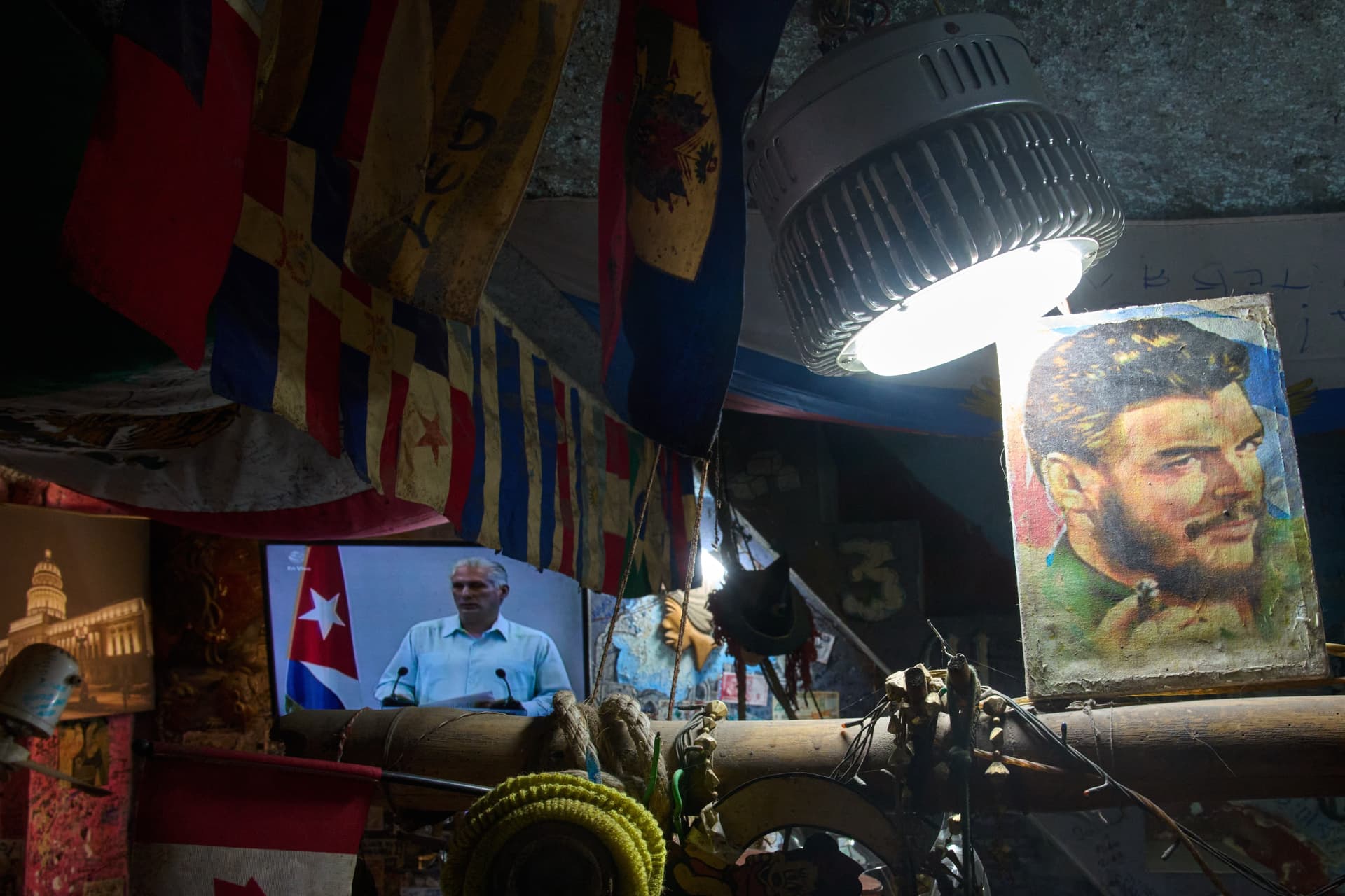 AP Photo/Ramon Espinosa An image of Marxist revolutionary Ernesto "Che" Guevara stands next to a TV showing Cuban President Miguel Díaz-Canel speaking, inside a souvenir shop at Havana, Cuba, on March 13, 2026.