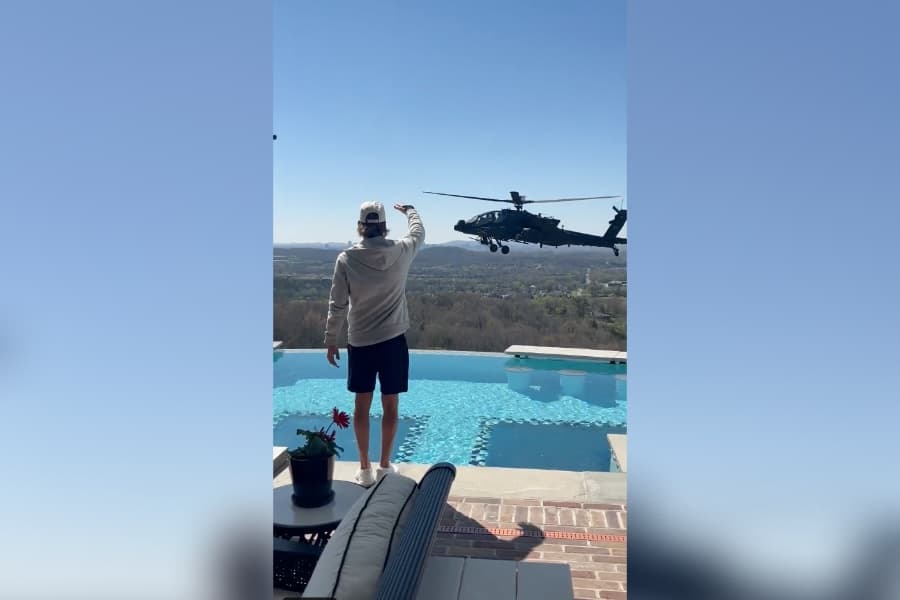 X.com Singer Kid Rock salutes an Army helicopter hovering over his Nashville home Saturday.