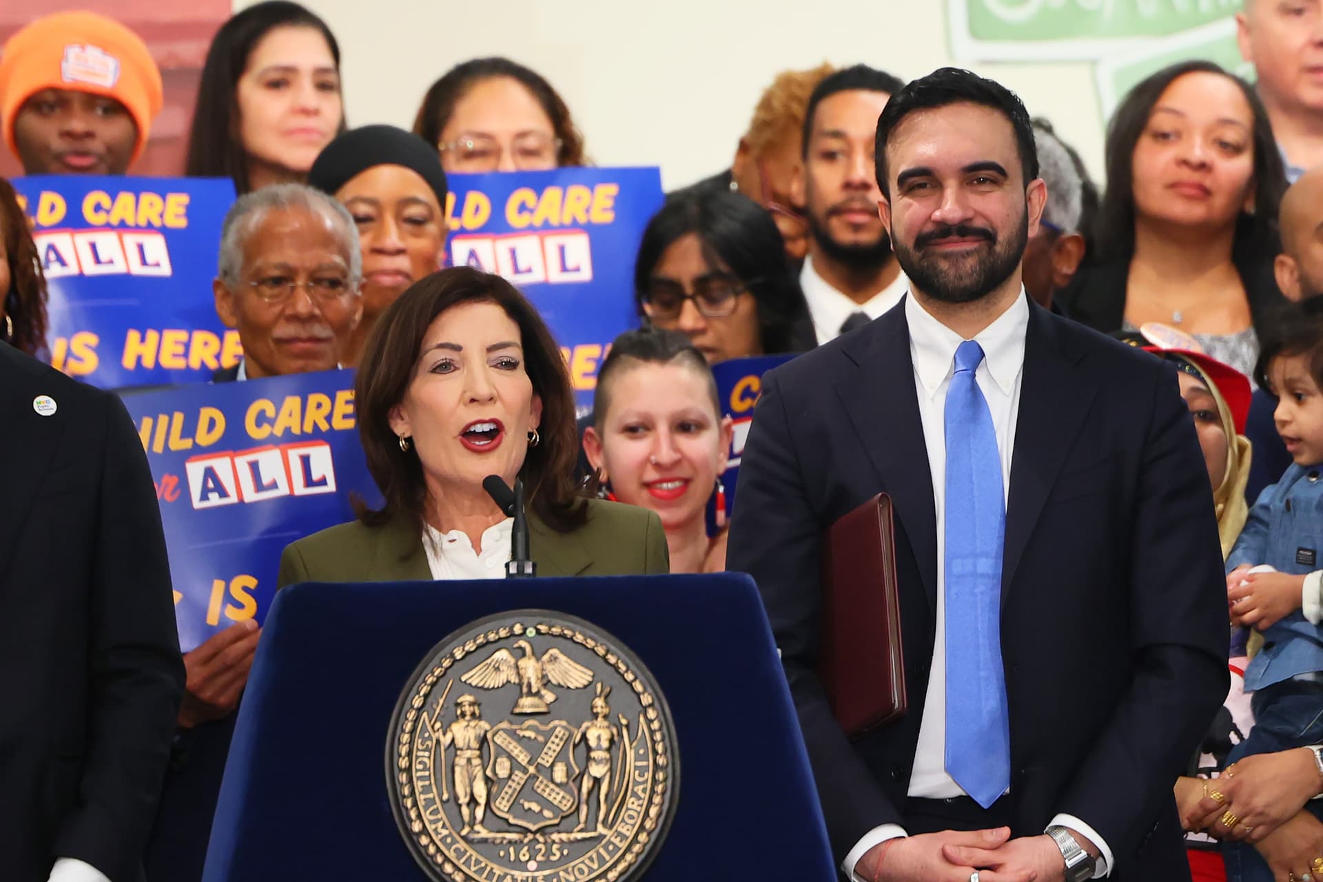 Michael M. Santiago/Getty Images Mayor Zohran Mamdani, left, listens as Governor Kathy Hochul speaks on March 3, 2026 at New York City.
