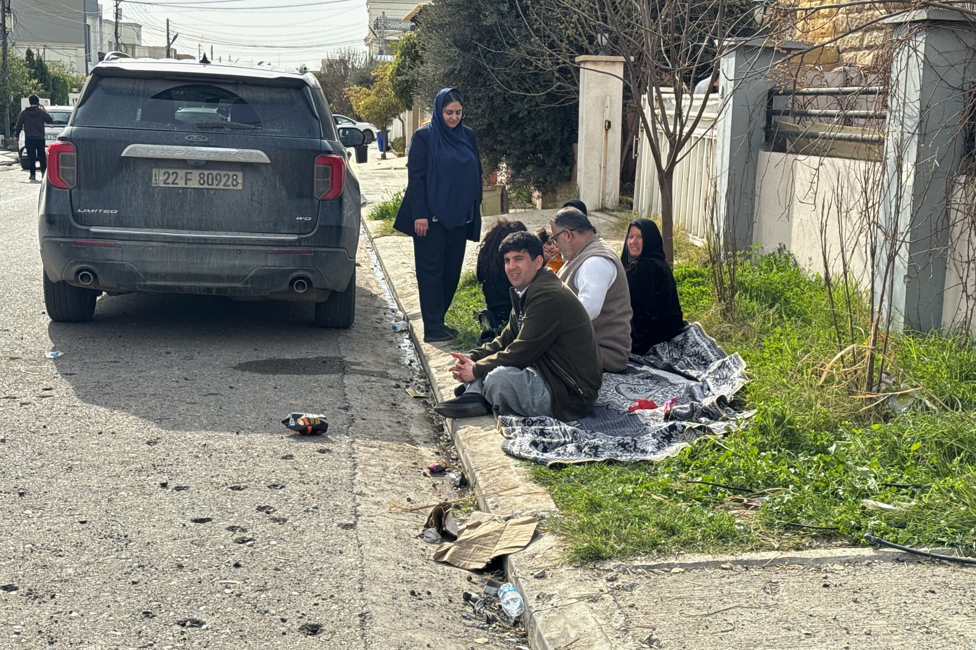 AP/Salar Salim Kurds sit outside their homes, damaged following a drone attack that struck their neighbourhood in Irbil, Iraq, March 4, 2026.