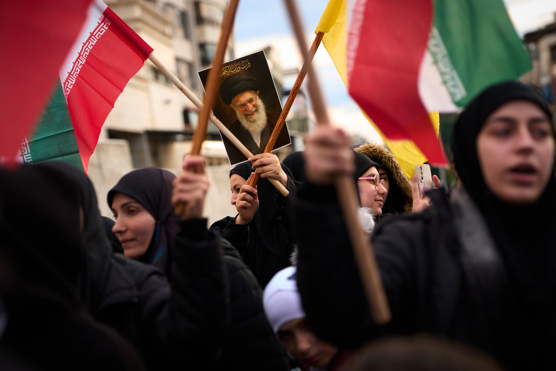 AP/Emilio Morenatti A woman holds a portrait of Iran's late Supreme Leader during a protest outside Iran's embassy at Beirut.