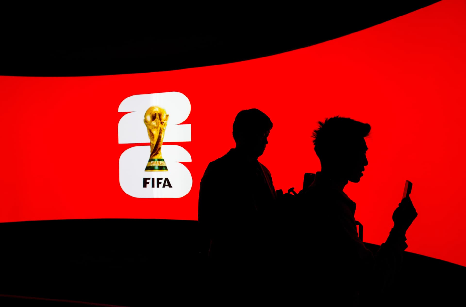 Darryl Dyck/The Canadian Press via AP People are silhouetted against a video screen during the launch of the FIFA World Cup trophy tour at Vancouver, Canada, on April 10, 2026.