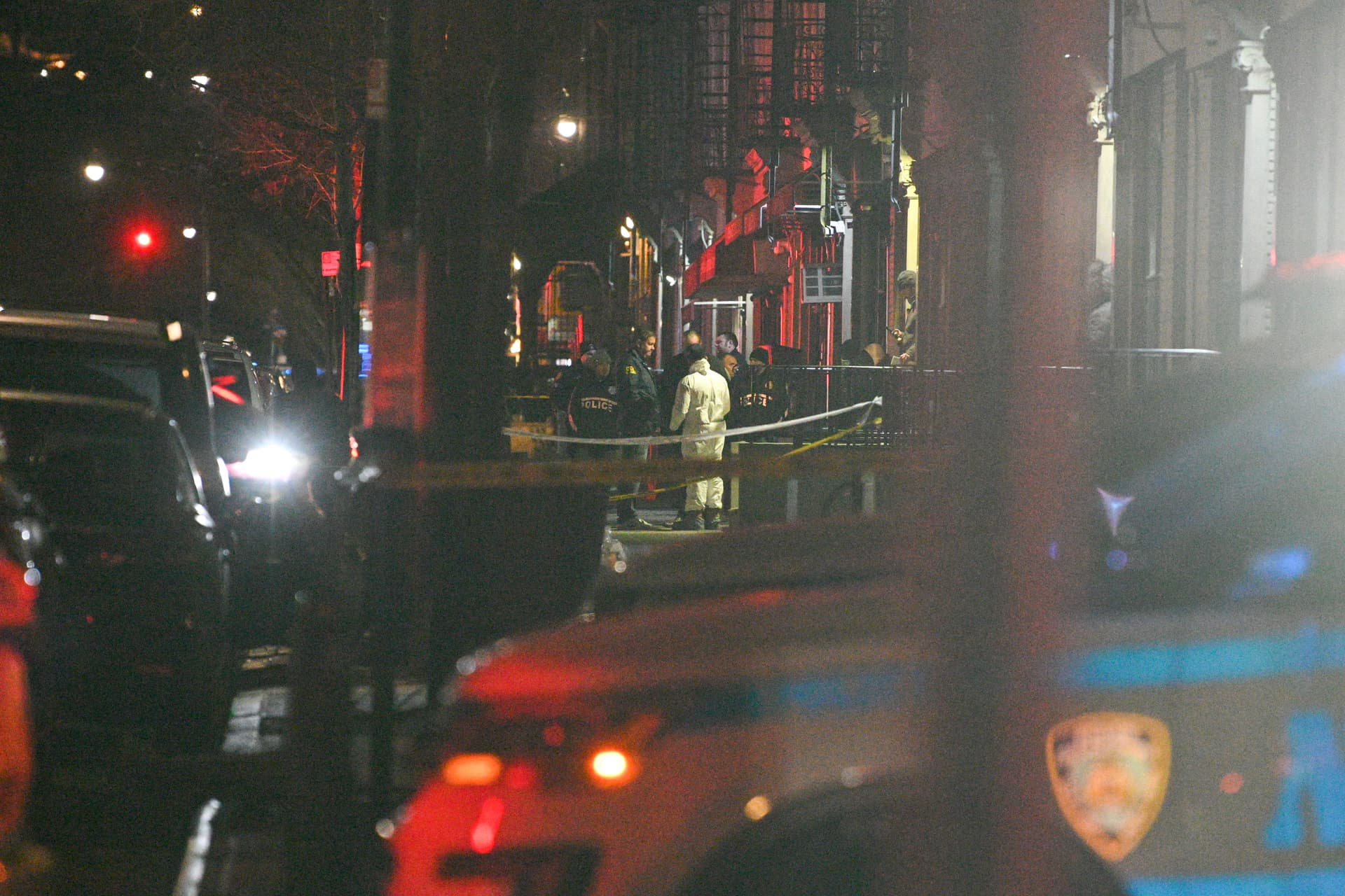 Alexi Rosenfeld/Getty Images NYPD and FBI officers investigate a crime scene in Harlem.