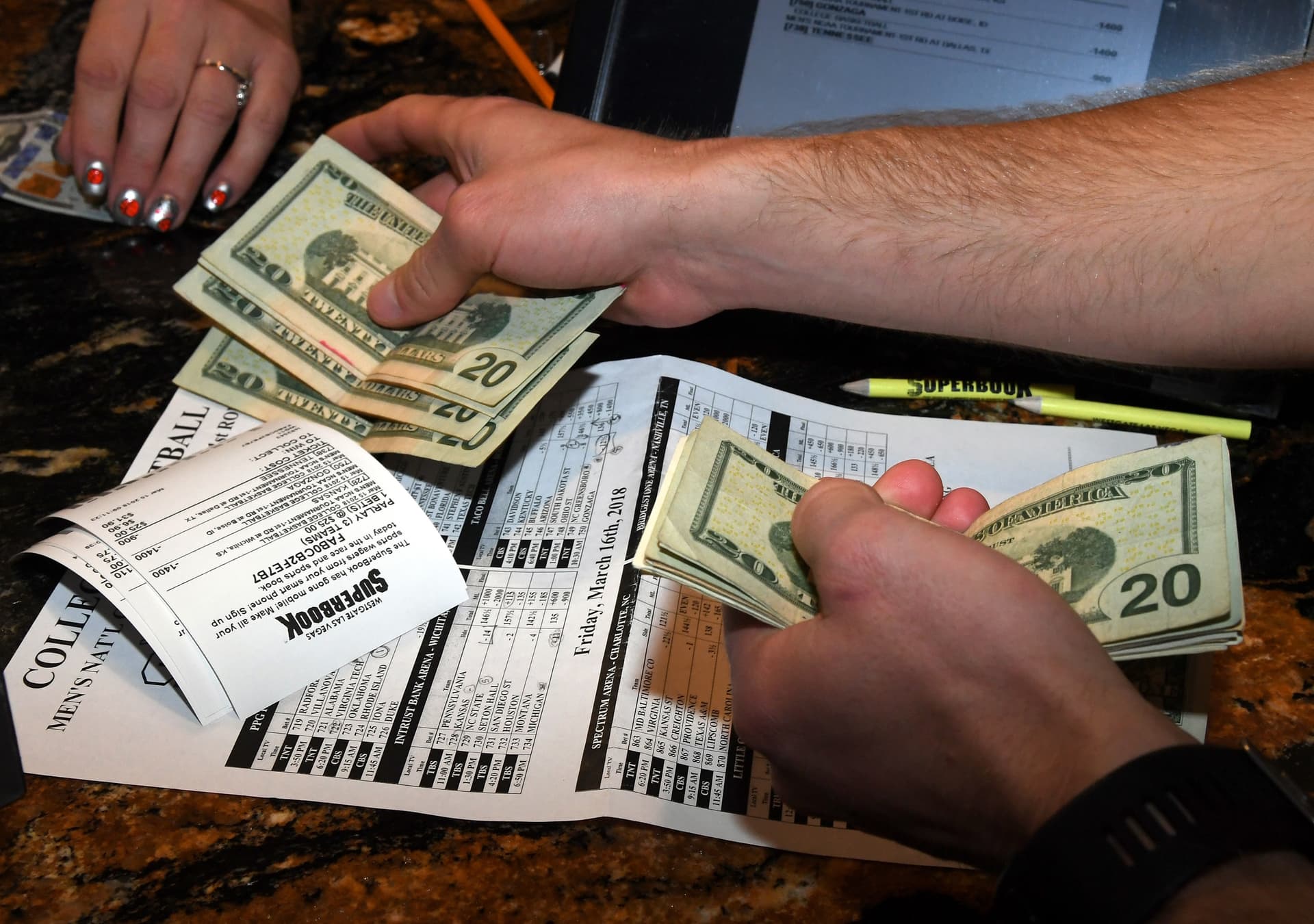 Ethan Miller/Getty Images A man places bets during a viewing party for the NCAA Men's College Basketball Tournament at a casino at Las Vegas on March 15, 2018.