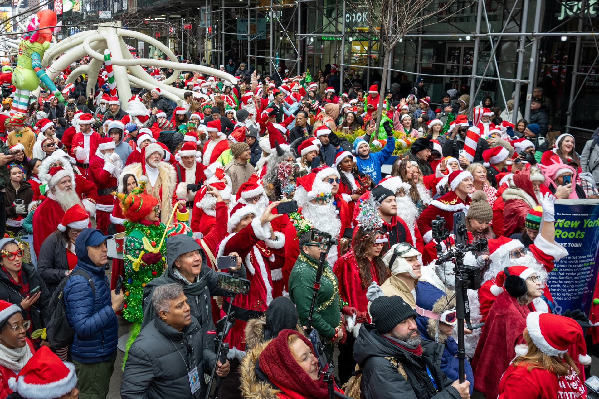 Jeremy Weine/Getty Images Revelers in holiday character costumes take part in the SantaCon bar crawl on December 13, 2025, at New York City.