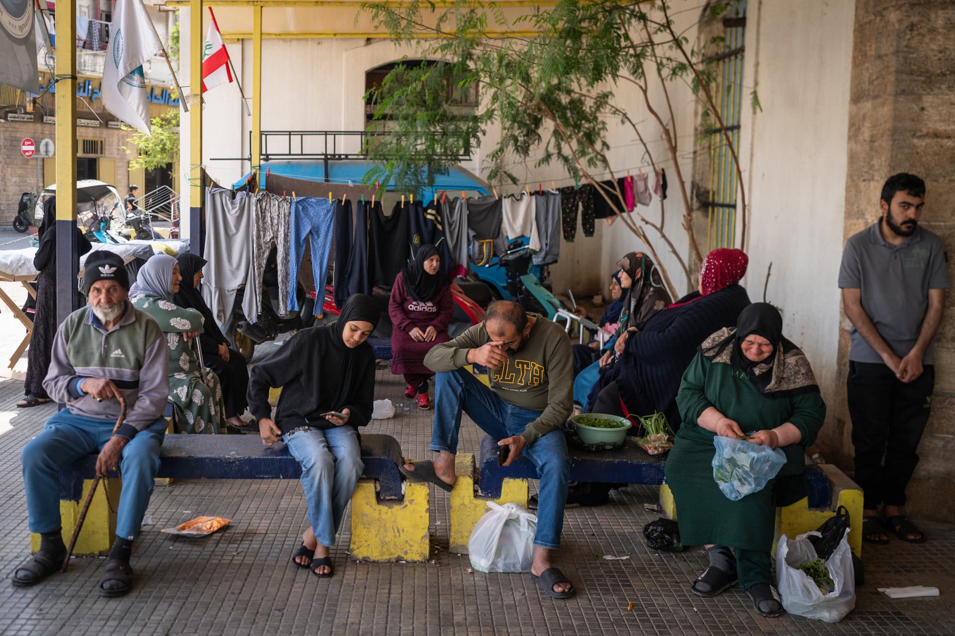 Adri Salido/Getty Images Families sit in front of a shelter for internally displaced people at Sidon, Lebanon, on April 27, 2026.