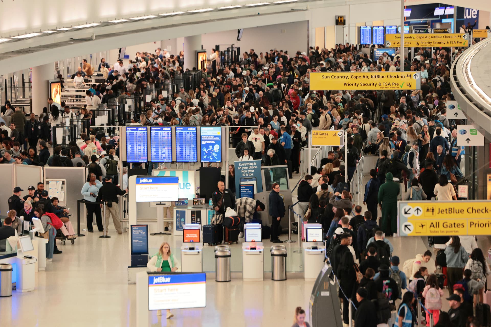 Michael M. Santiago/Getty Images Travelers wait in line to go through security in Terminal 5 at John F. Kennedy International Airport on March 27, 2026.