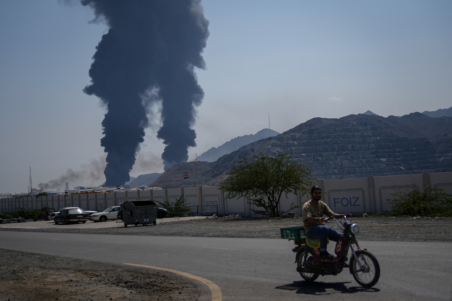 Altaf Qadri/AP Plumes of smoke rise after debris from an intercepted Iranian drone struck an oil facility at Fujairah, United Arab Emirates, on March 14, 2026.