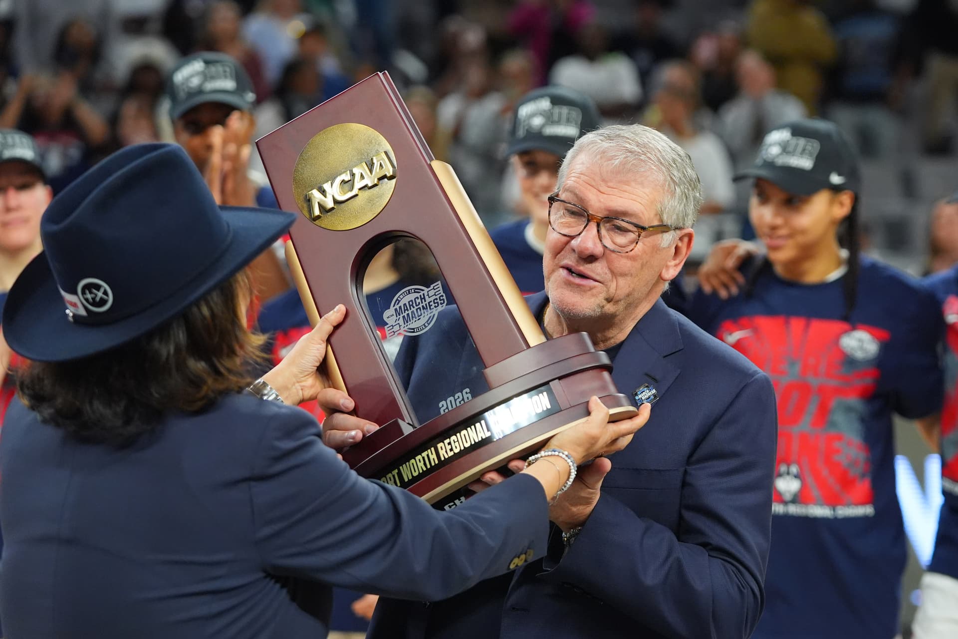 LM Otero/AP UConn’s women’s head coach, Geno Auriemma, is presented with a regional championship trophy after his team defeated Notre Dame to advance to the Final Four at Fort Worth, Texas, on March 29, 2026.