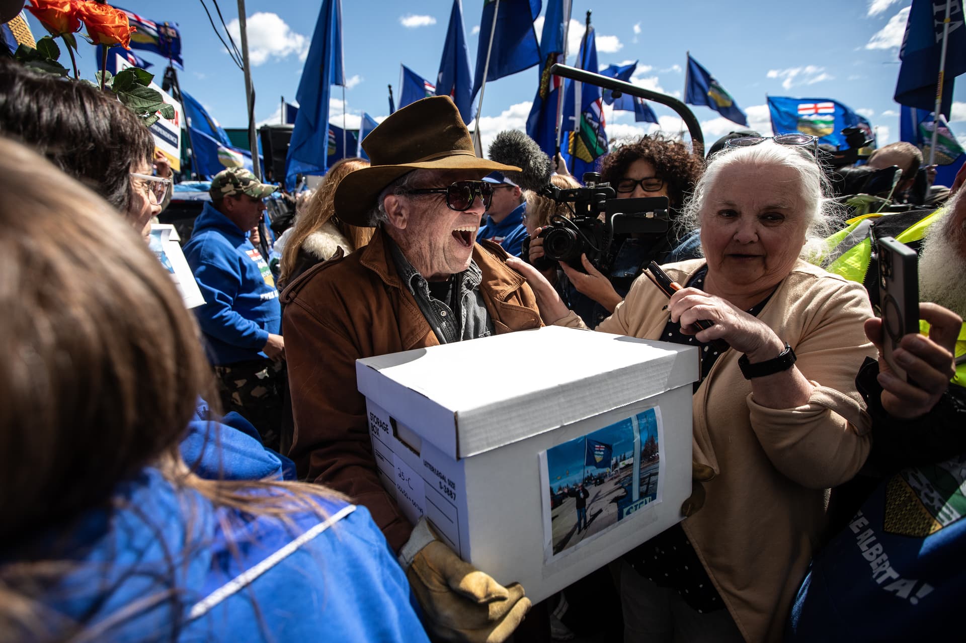 Jason Franson/Canadian Press via AP Supporters carry boxes of signatures to submit for an Alberta separation referendum at Edmonton on May 4, 2026.