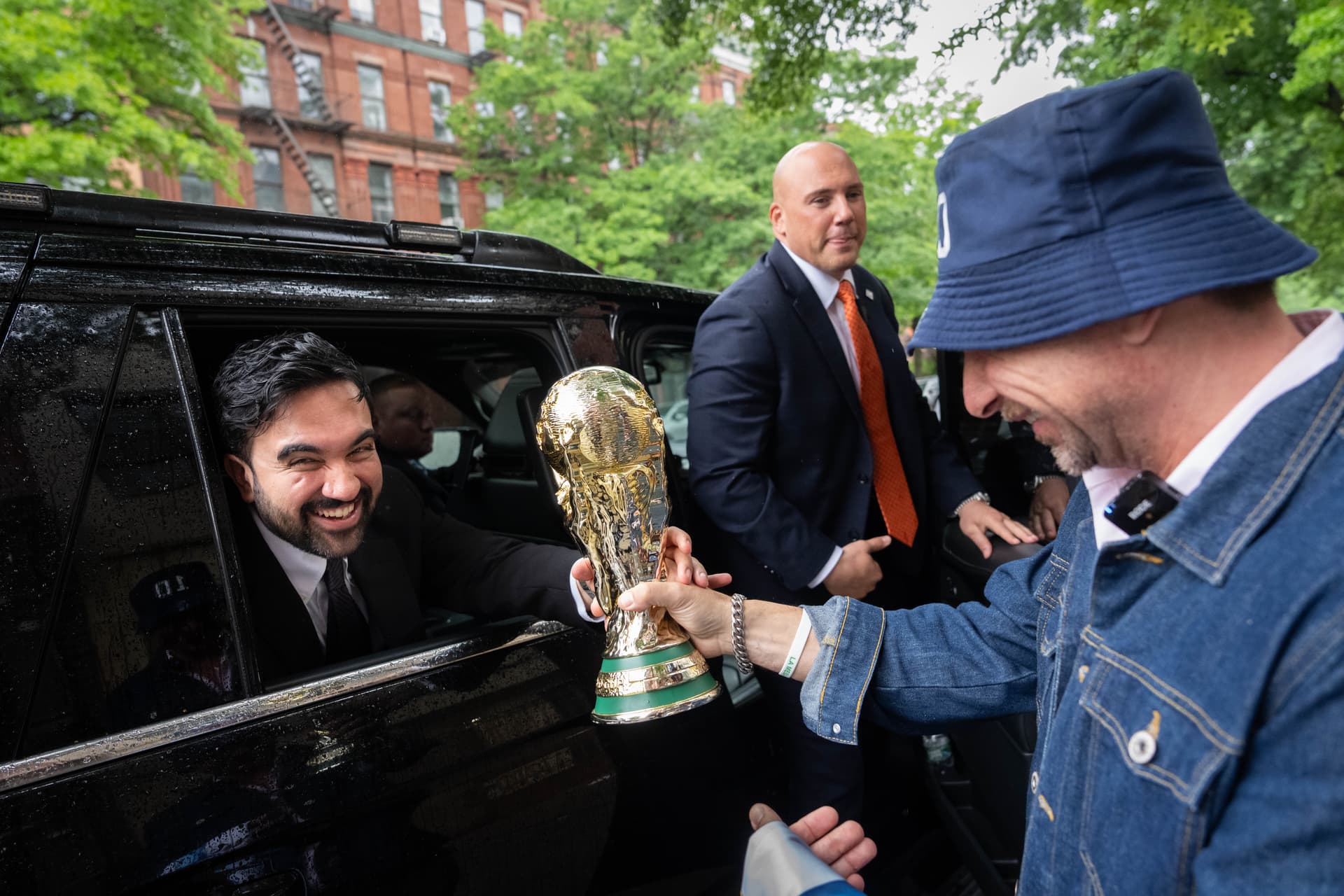 AP Photo/Adam Gray New York Mayor Zohran Mamdani is passed a replica World Cup Trophy.