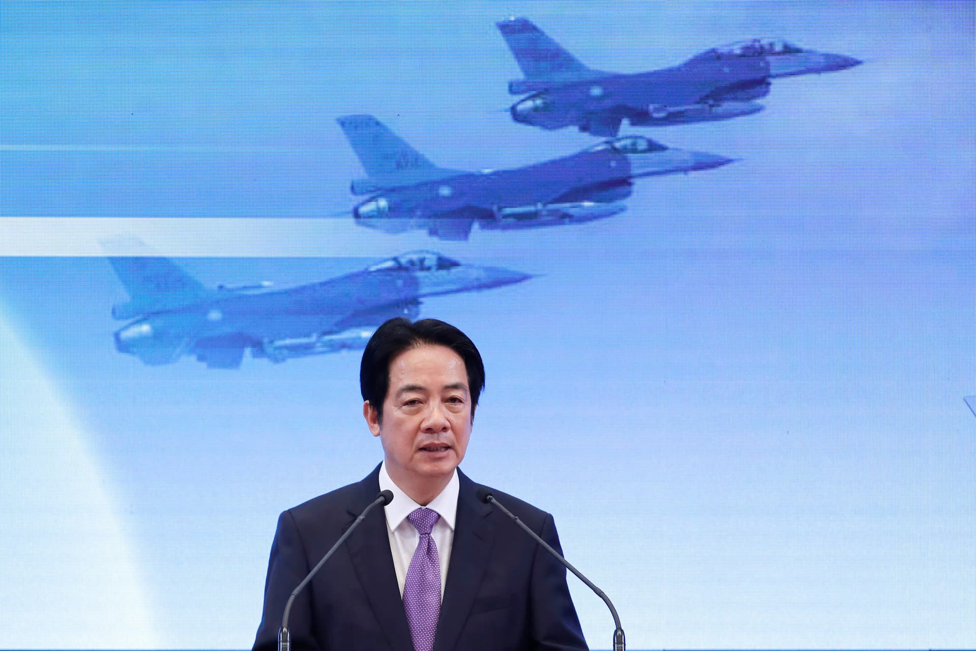 Chiang Ying-ying/AP President Lai Ching-te speaks in front of a video screen showing jet fighters in flight during a press conference at Taipei, Taiwan, on May 20, 2026.