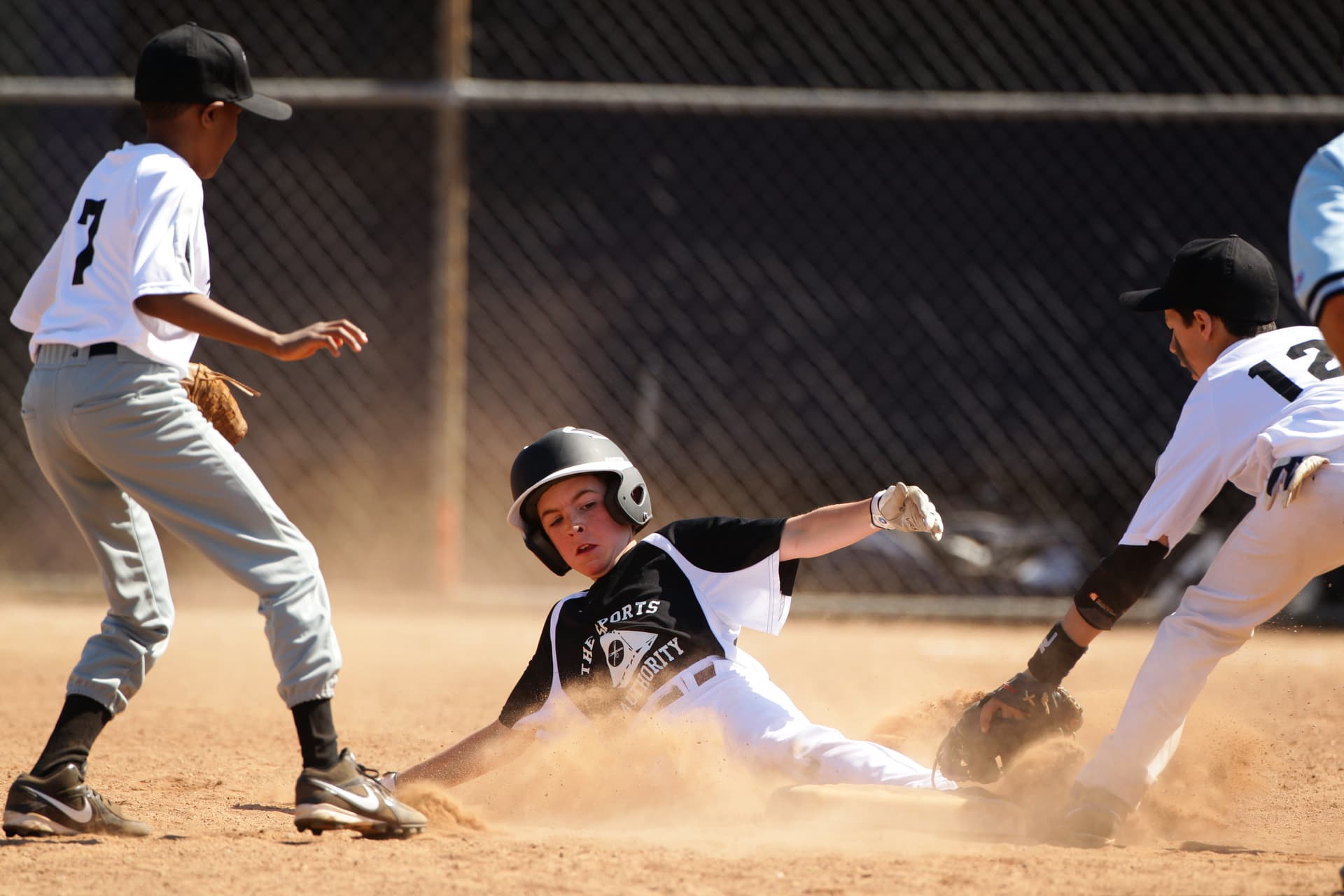 Tim Clayton/Corbis via Getty Images A young baseball player slides into second base during a Little League competition at Norwalk, Connecticut.