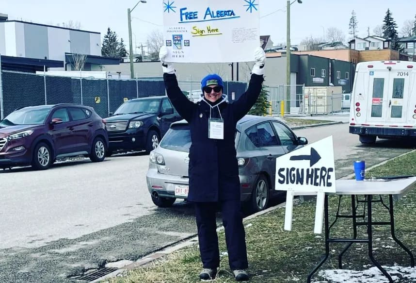 Via Instagram An Alberta separatist holds up a sign seeking signatures to support a ballot question on breaking away from Canada.