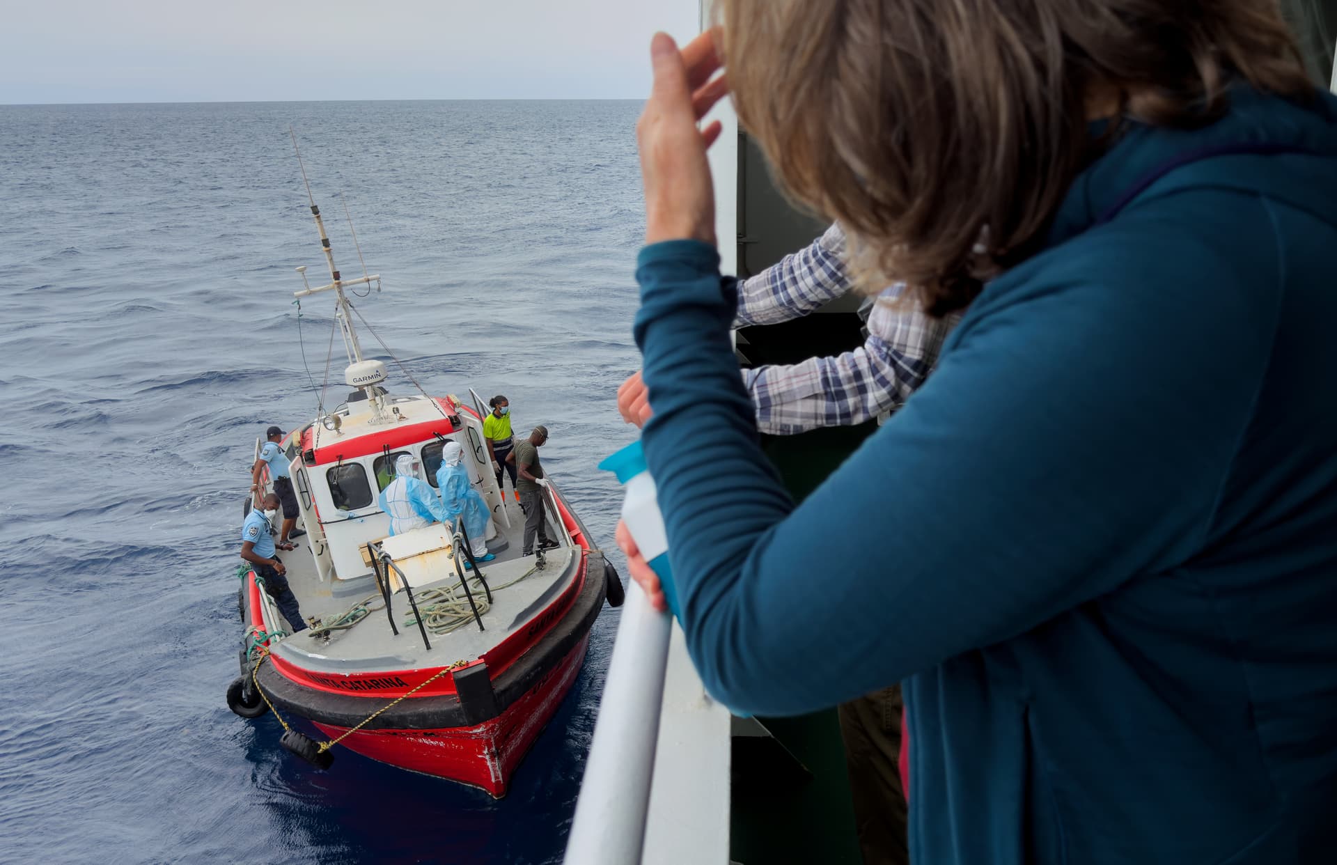 AP Photo Passengers on the hantavirus-stricken cruise ship, MV Hondius, watch epidemiologists board the ship at Praia, Cape Verde, on May 6, 2026.