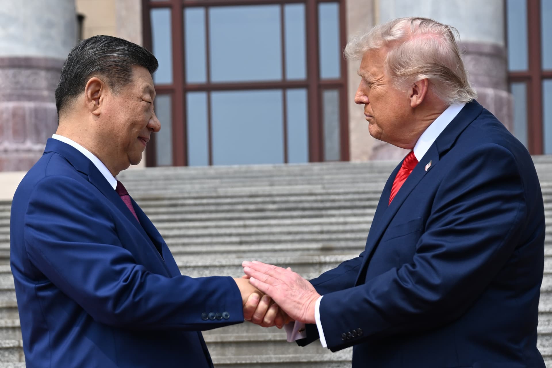 Kenny Holston/pool via AP President Xi Jinping, left, shakes hands with President Trump at the Great Hall of the People, Beijing, May 14, 2026.