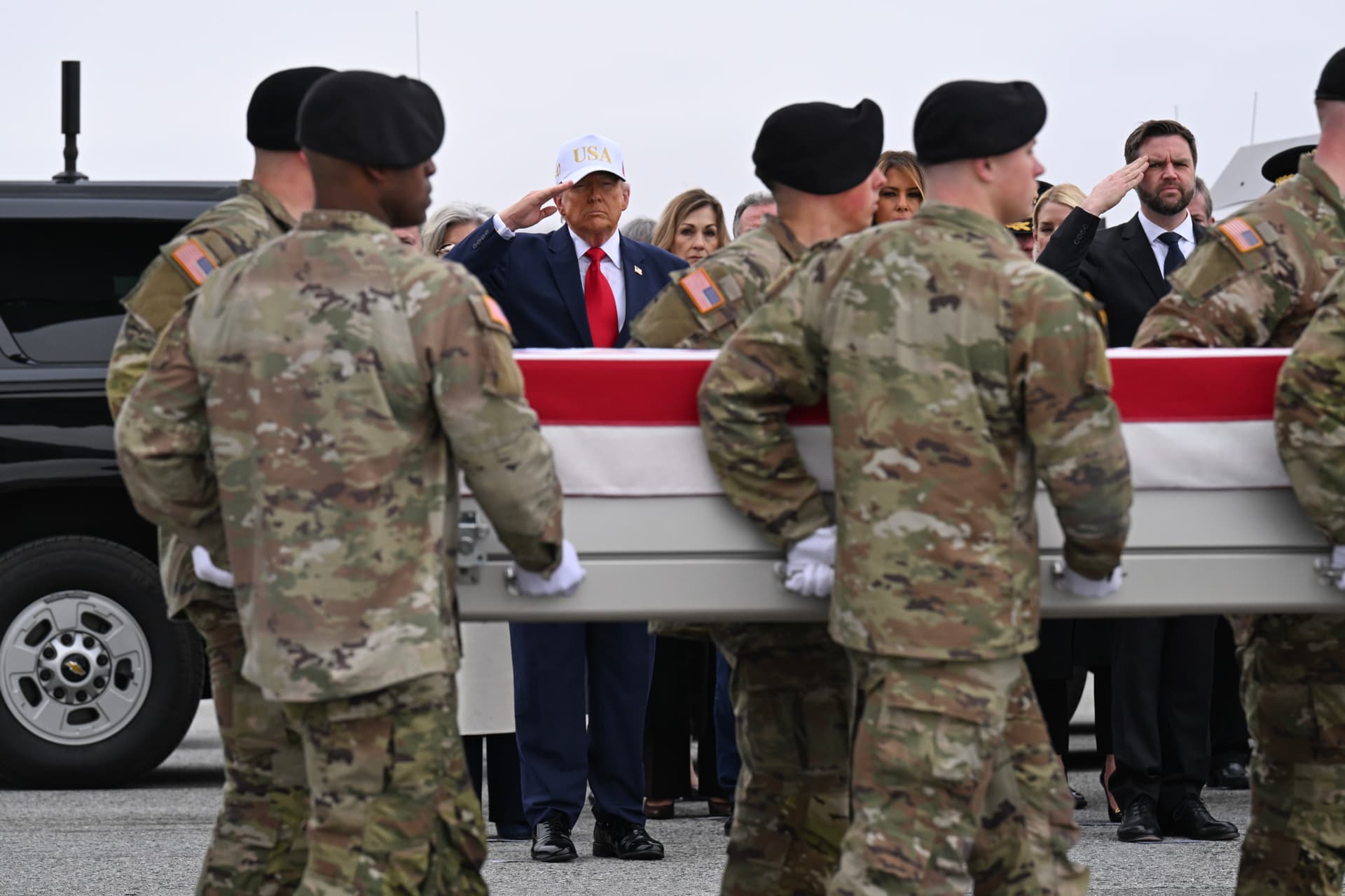 Roberto Schmidt/Getty Images At Dover Air Force Base, Delaware, on March 7, 2026, President Trump and Vice President Vance salute a flag-draped transfer case containing the remains of a soldier killed during the Iran War.