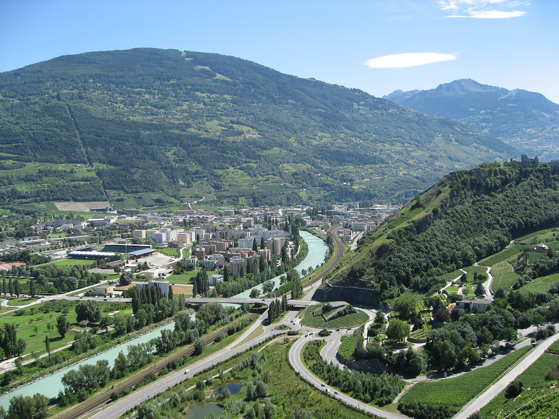 By Londo Mollari - via Wikipedia, CC BY-SA 2.0 View of Sion from Bisse de Clavau in Switzerland's Rhone Valley.