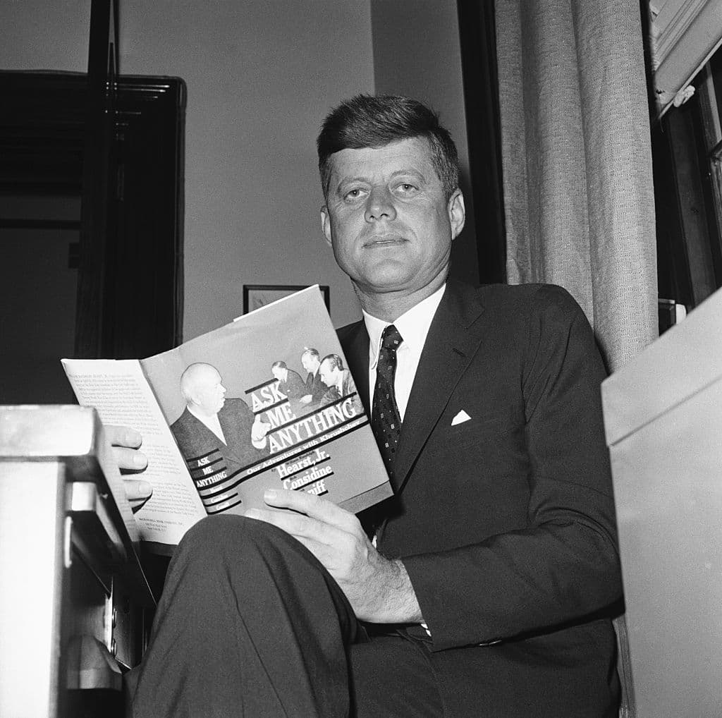Via Bettmann, Getty Images John F. Kennedy reading 'Ask Me Anything,' by William Randolph Hearst Jr., and others, in June 1960.