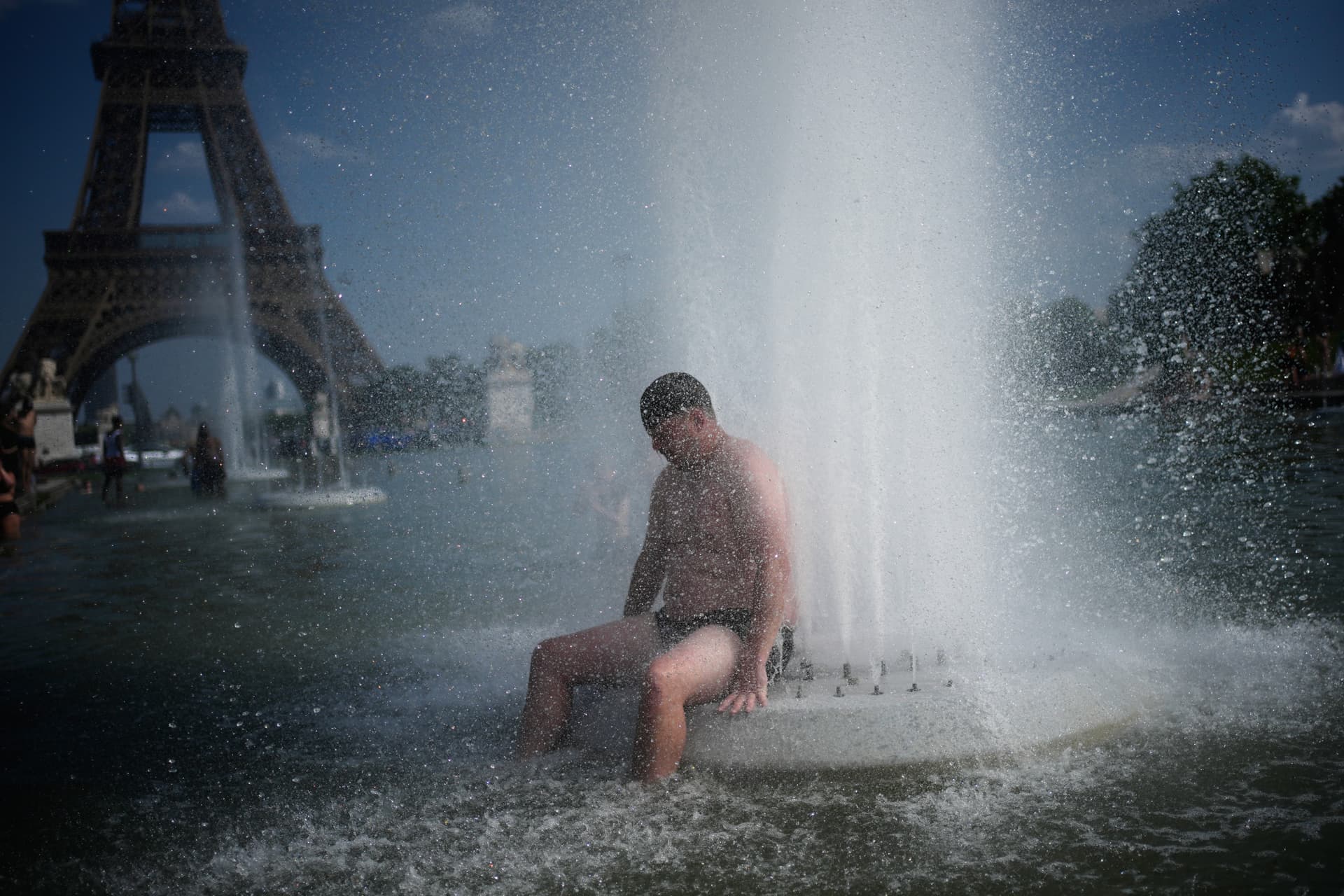 Christophe Ena/AP A person cools off at Trocadero fountain near the Eiffel Tower during a heat wave at Paris on June 24, 2026.