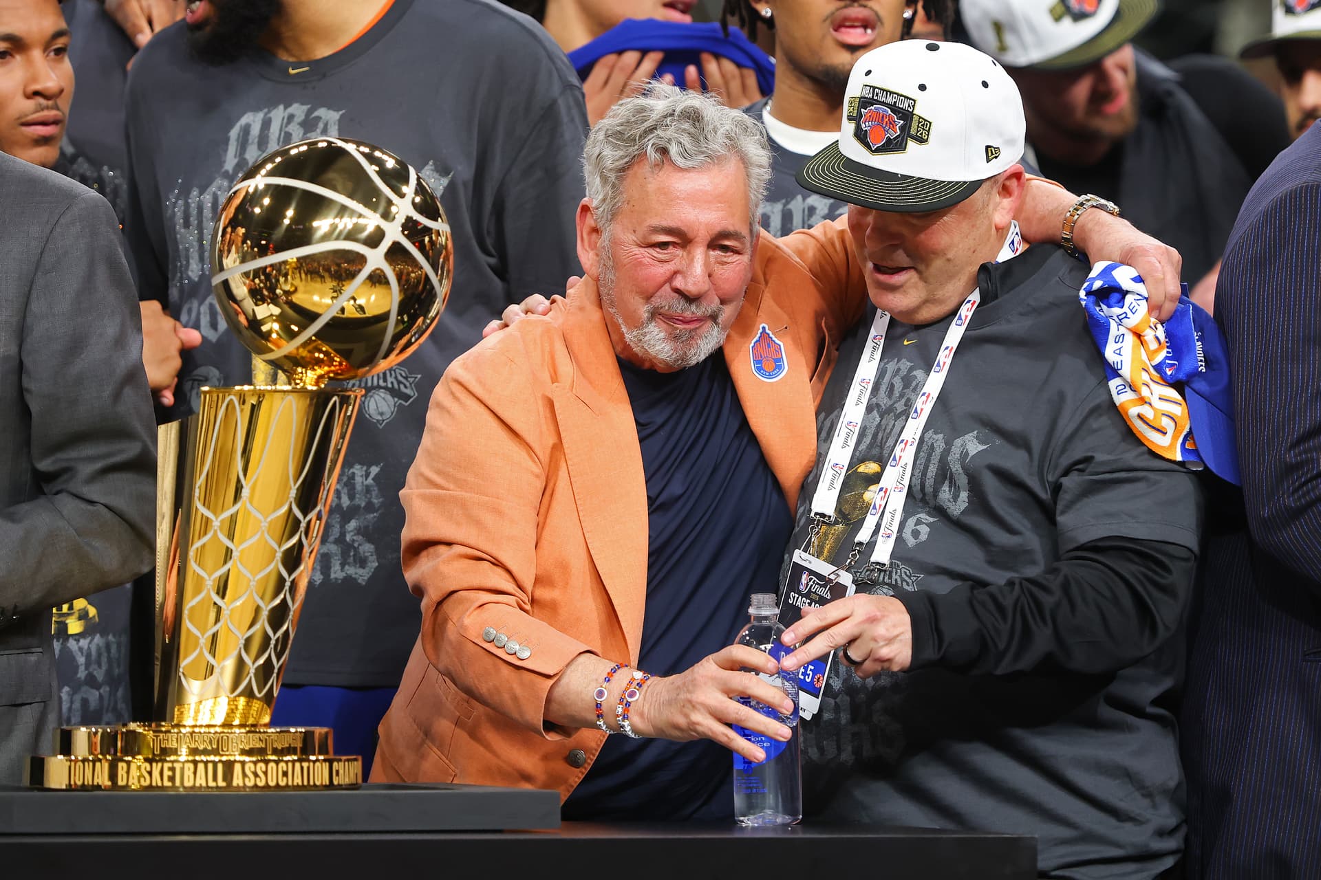 Gregory Shamus/Getty Images New York Knicks owner James Dolan and president Leon Rose celebrate behind the Larry O'Brien Championship Trophy after their team defeated the San Antonio Spurs in Game Five of the 2026 NBA Finals, June 13, 2026.