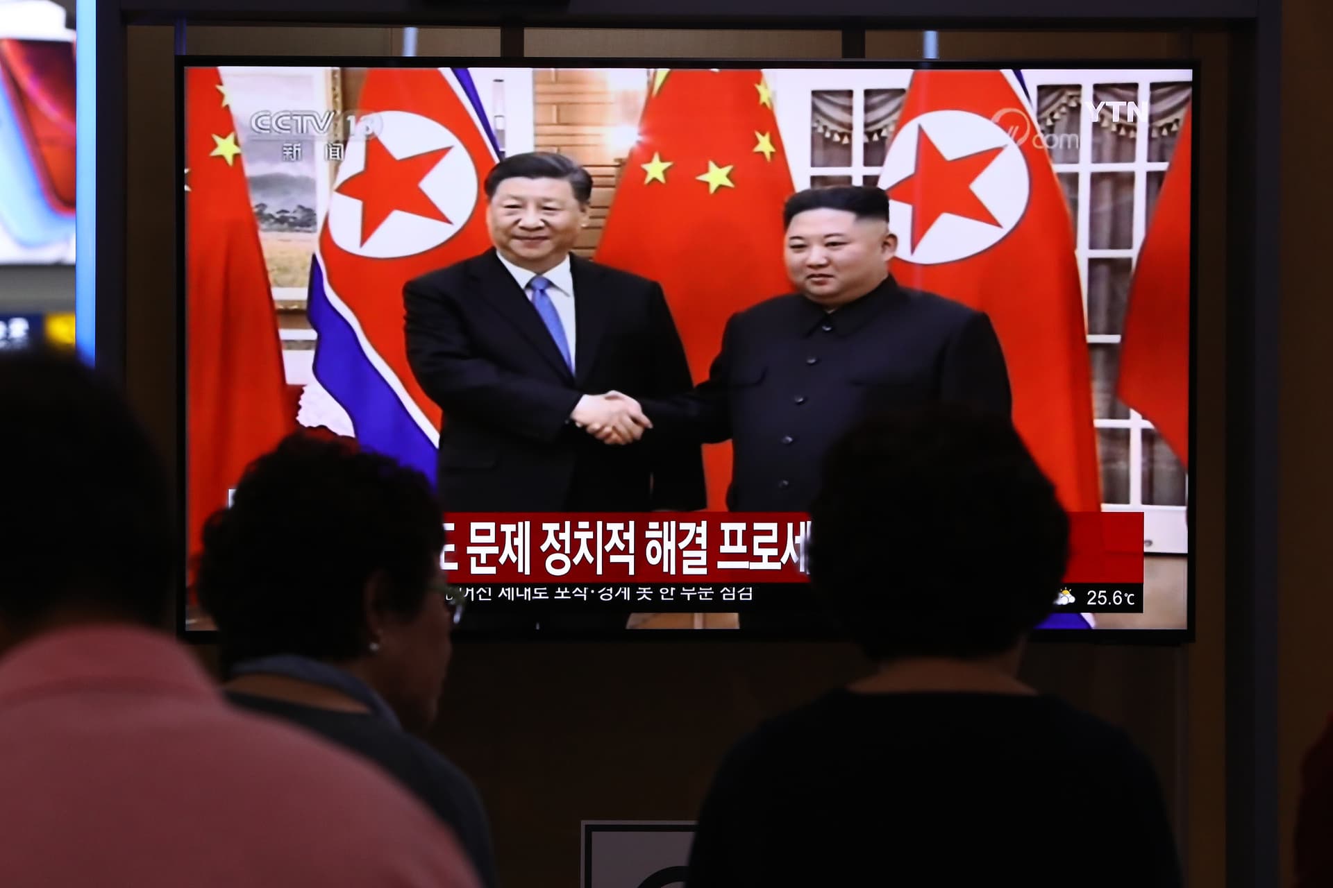 Chung Sung-Jun/Getty Images South Koreans watch on a screen showing Kim Jong-un shaking hands with President Xi Jinping at the Seoul Railway Station on June 20, 2019.