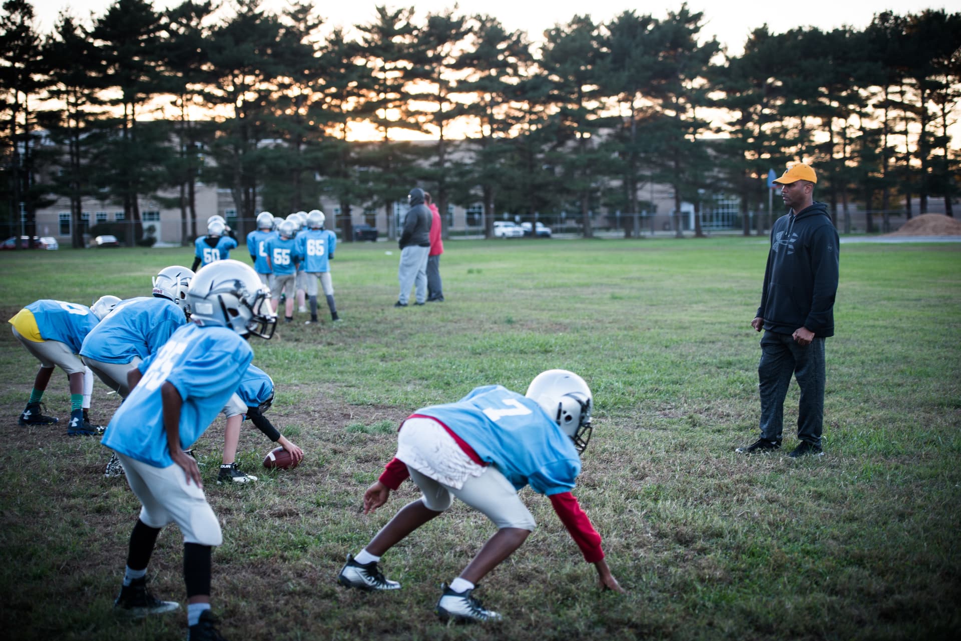 Damien Taylor via DVIDS A football coach supervises practice drills.