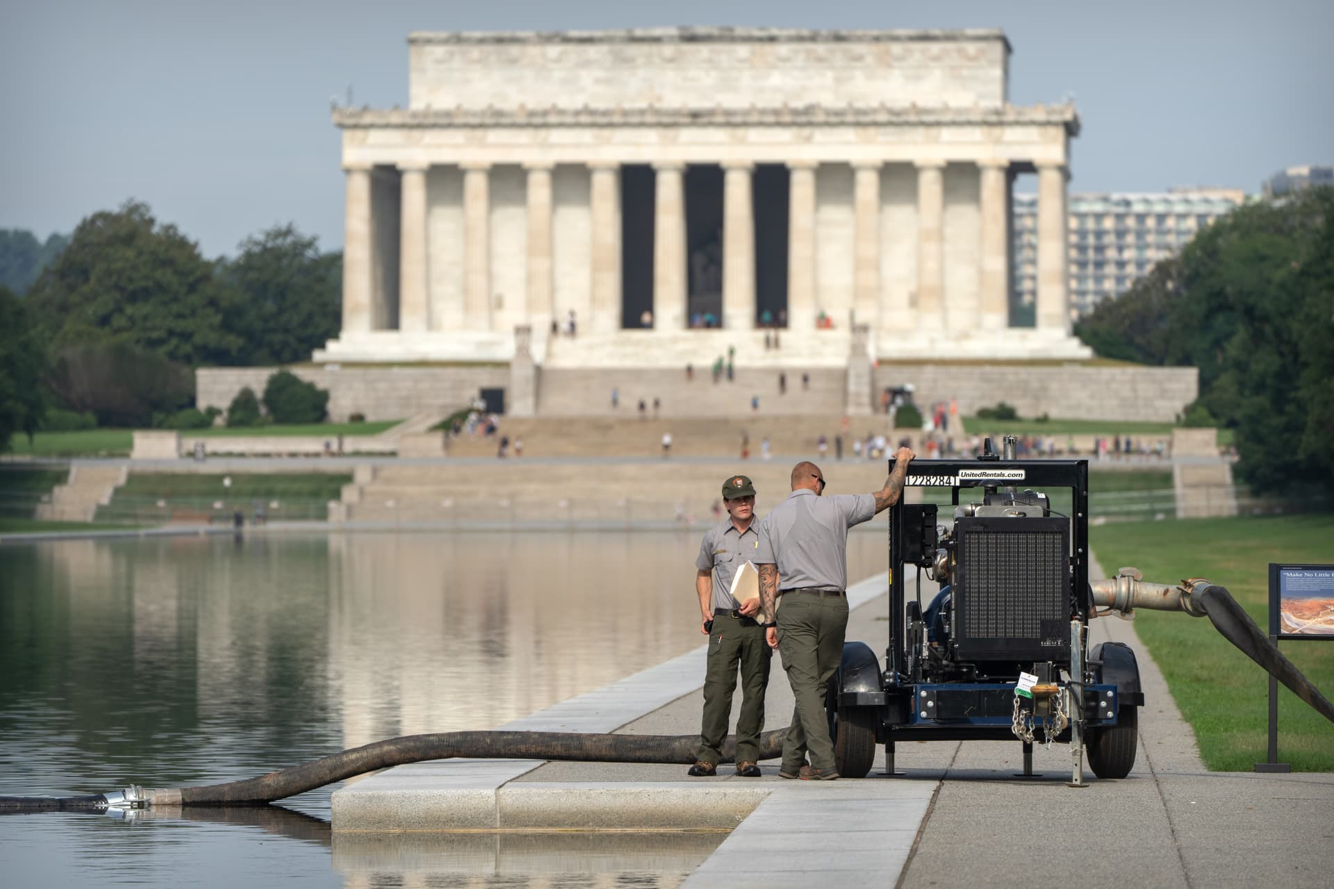 Mark Schiefelbein/AP National Park Service workers stand near a pump placed next to the Lincoln Memorial Reflecting Pool at Washington, D.C., on July 10, 2026.