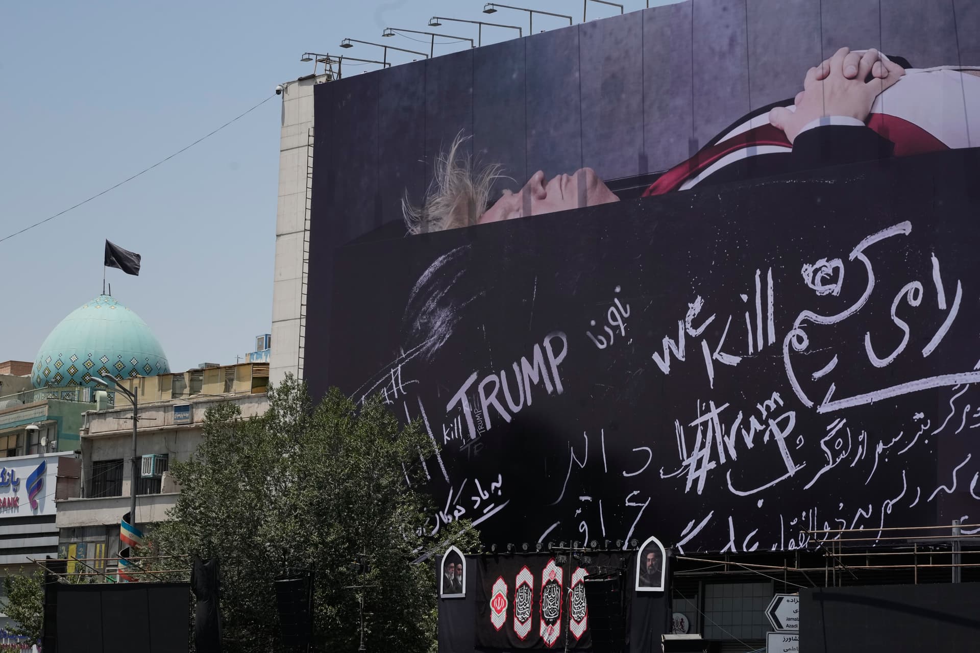 Vahid Salemi/AP A billboard depicting President Trump lying on what appears to be a coffin and bearing anti-Trump messages is seen at Islamic Revolution Square at Tehran, Iran, on July 15, 2026.