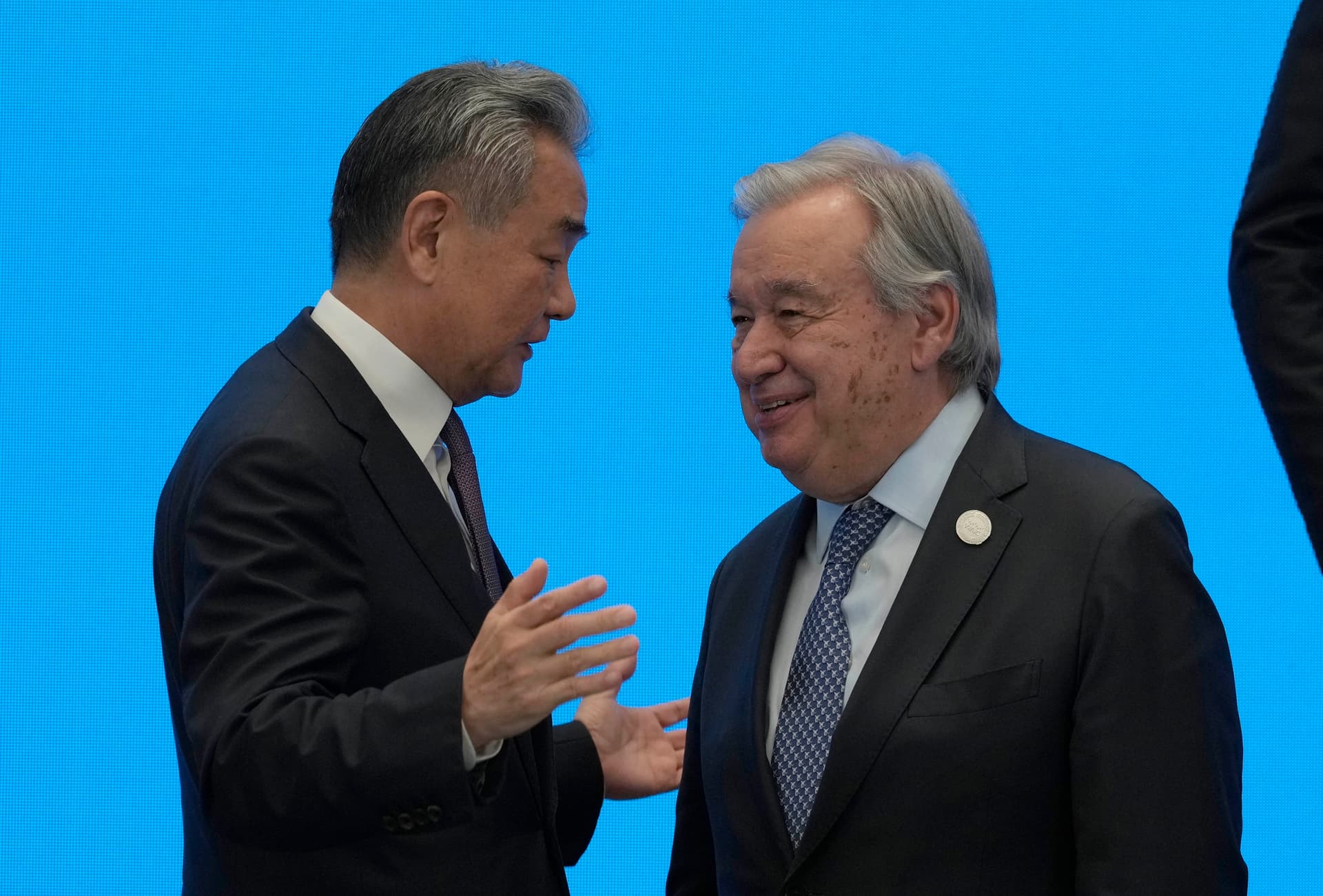 Ng Han Guan-Pool/Getty Images China’s foreign minister, Wang Yi, shakes hands with UN Secretary-General António Guterres on July 16, 2026, ahead of the World AI Conference at Shanghai.