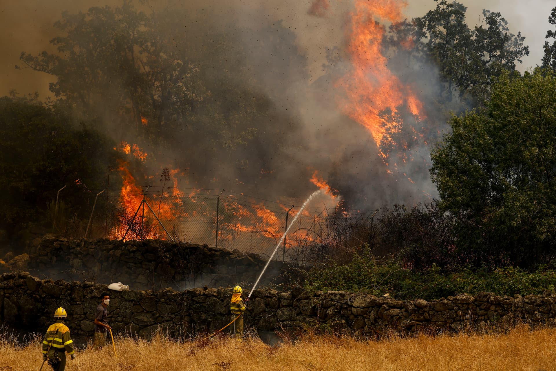 Pablo Blazquez Dominguez/Getty Images Firefighters battle a wildfire as it approaches houses in Ávila province, Spain, on July 24, 2026.