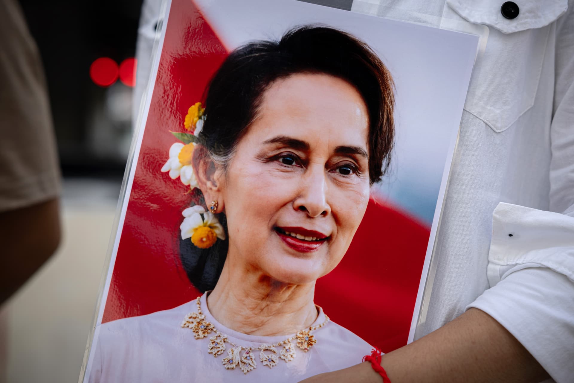 Lauren DeCicca/Getty Images Myanmar migrant group members hold a framed photo of Aung San Suu Kyi, who was recently moved from prison to house arrest, during a Labor Day rally at the Bangkok Art and Culture Center on May 1, 2026 at Bangkok, Thailand.
