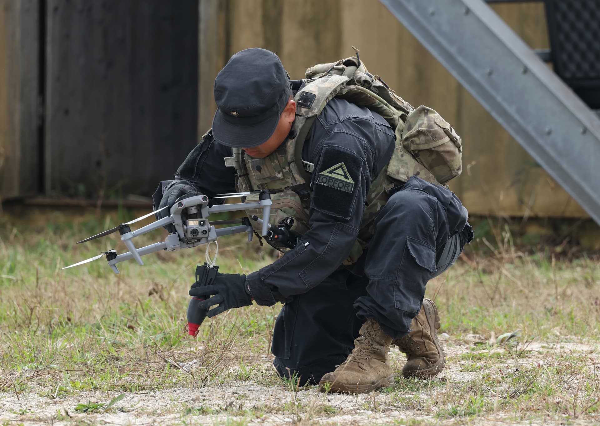 Sean Gallup/Getty Images A member of the U.S. Army 7th Army Training Command, clad in black in the role of opposition force, prepares an Autel FPV drone carrying live training bomblets during a demonstration for the media at the Saber Junction 26 combined military exercise at the U.S. Army Joint Multinational Readiness Center on August 26, 2026, near Hohenfels, Germany. The U.S. military is testing and acquiring a wide range of drone capabilities in response to the new combat realities born out of the ongoing Russian war in Ukraine.