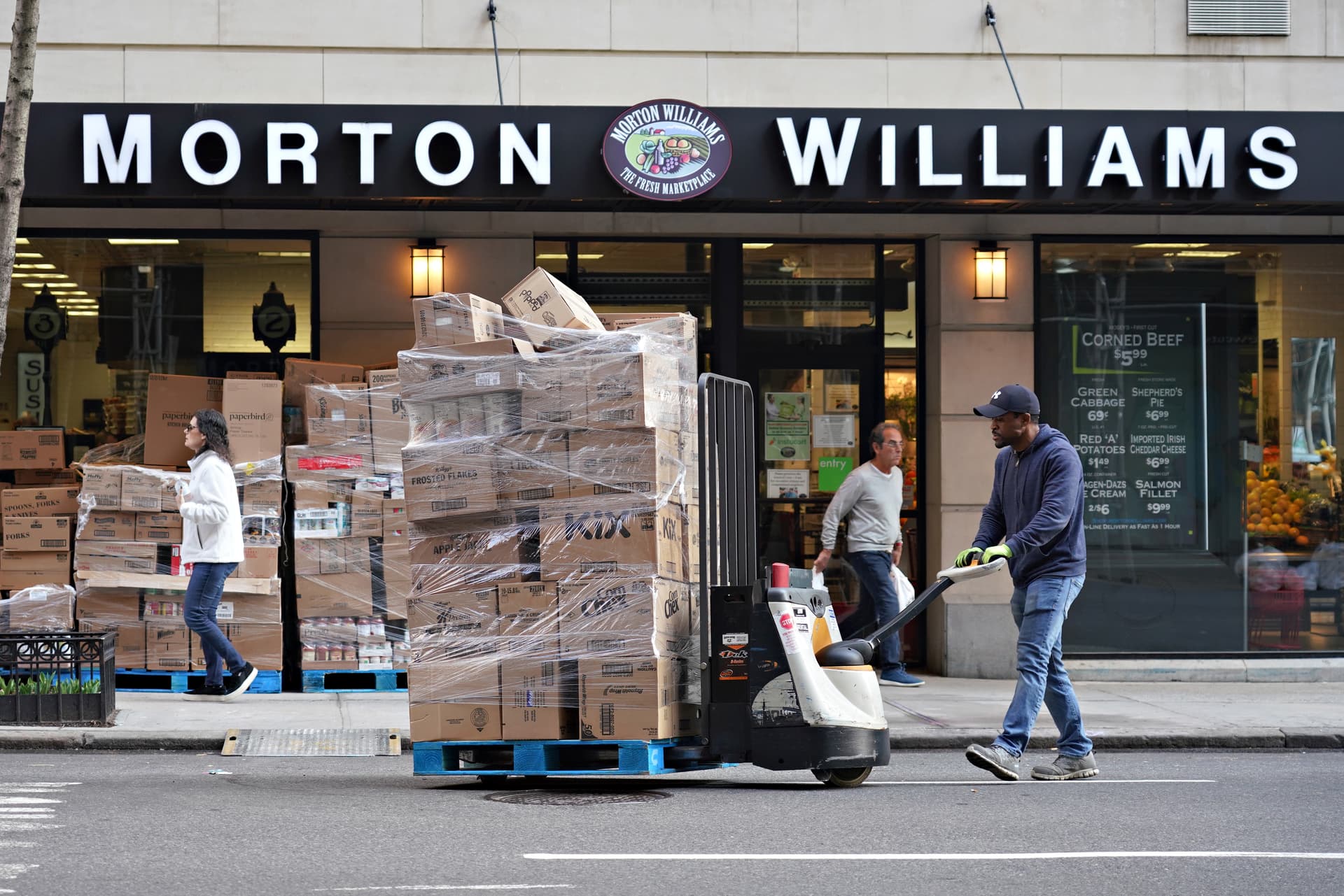 Cindy Ord/Getty Images A deliveryman moves supplies into a Morton Williams grocery store at New York City on March 20, 2020.