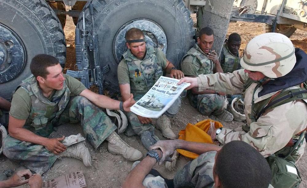 United States Navy via Getty Images American Marines in Iraq receive copies of the Stars and Stripes newspaper during the drive toward Baghdad on April 4, 2003.