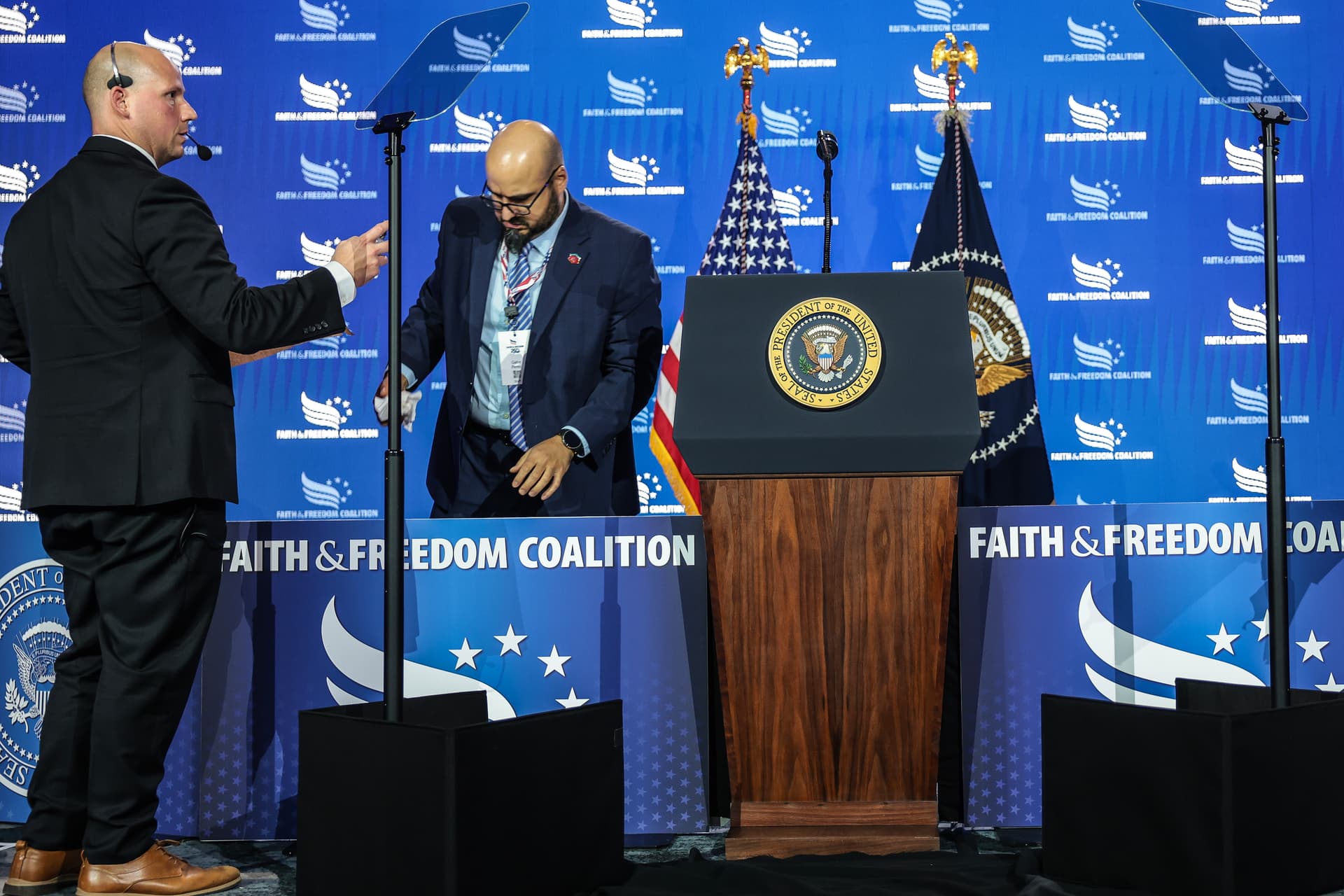 Anna Moneymaker/Getty Images White House staffers, including Gabriel Perez (right) set up a teleprompter before President Trump speaks at the Faith & Freedom Coalition's 2026 Policy Conference at Washington, D.C., on June 26, 2026.