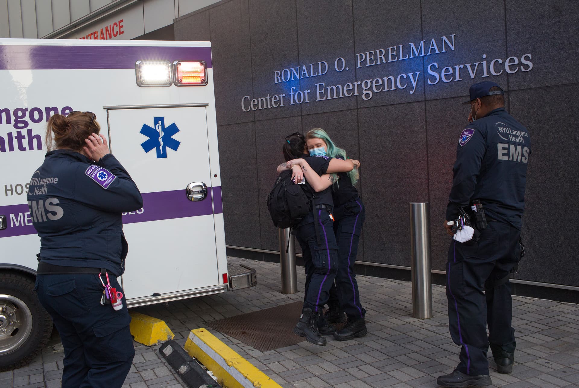 Andrew Lichtenstein/Corbis via Getty Images EMT paramedics hug outside the emergency room of NYU's Langone Hospital at New York CIty.