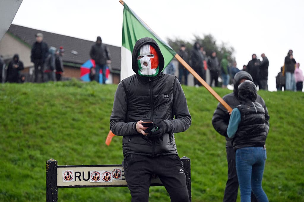 Charles McQuillan/Getty Images A protestor in an Irish flag balaclava at Portadown, Northern Ireland, September 29, 2026. .