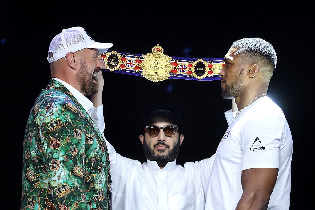 Photo by Richard Pelham/Getty Images for Netflix Tyson Fury and Anthony Joshua face off as Turki Al-Sheikh, Chairman of the General Entertainment Authority, watches on during the announcement for their fight on September 30, 2026 in London, England.