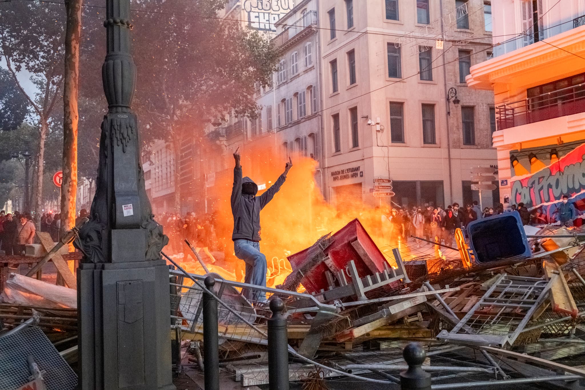 Sener Yilmaz Aslan/Getty Images A protester gives the police the middle finger from between barricades on October 17, 2026, at Marseille, France.