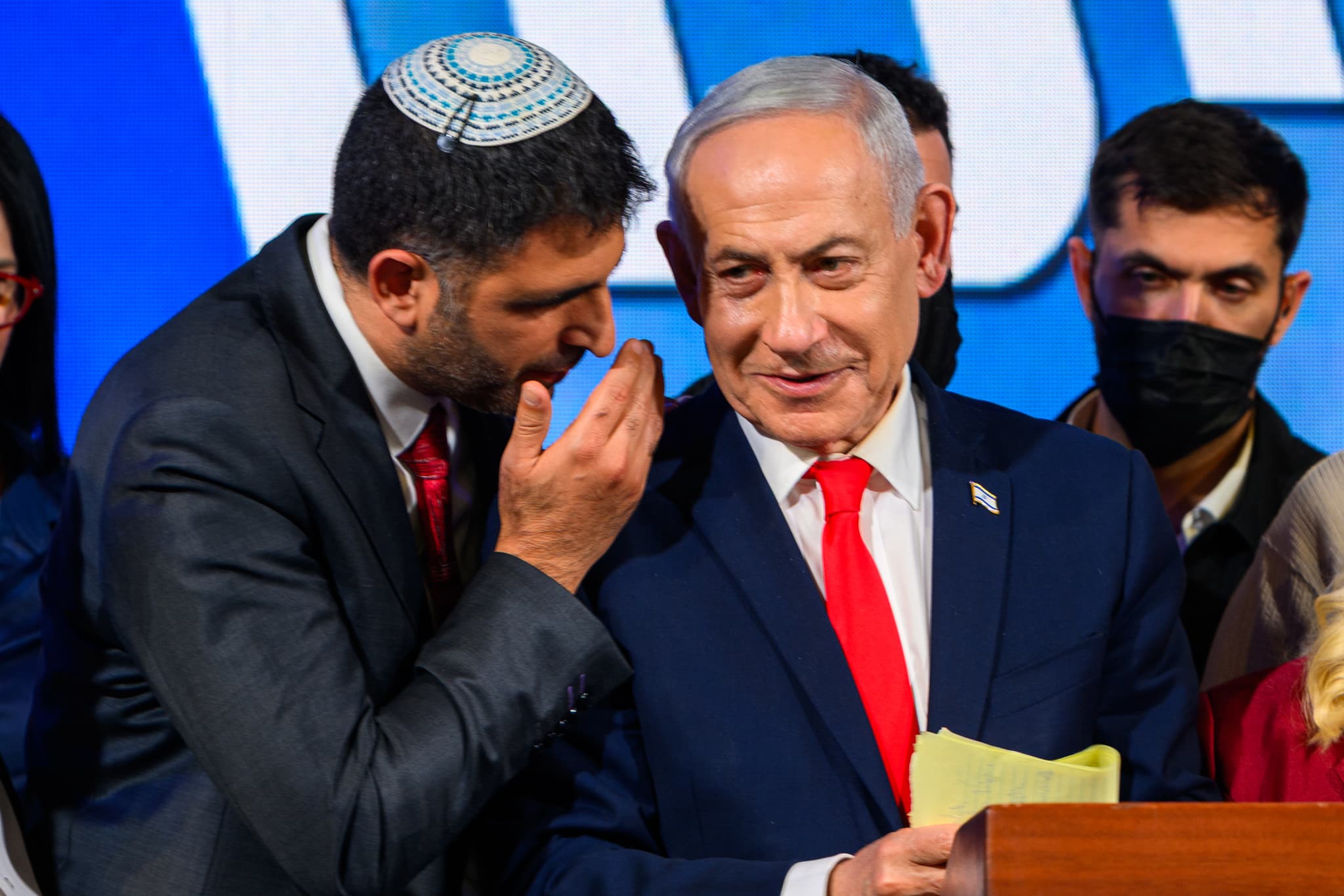 Alexi J. Rosenfeld/Getty Images Dr. Shlomo Karhi, Minister of Communications, whispers to Prime Minister and Likud party leader Benjamin Netanyahu at the Likud Party election-night event at the Teddy Hall, International Convention Center on October 28, 2026 at Jerusalem, Israel.