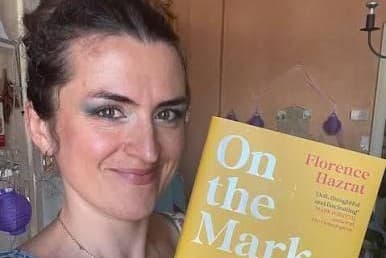 Via X Author Florence Hazrat displays a copy of her new book ‘On the Mark,’ in July, 2026.