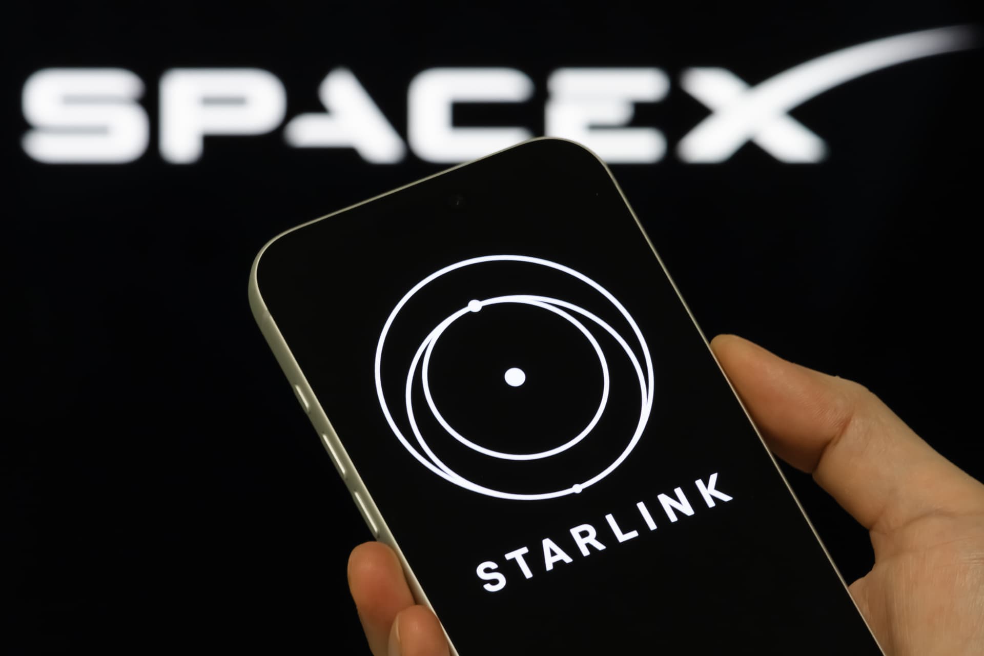 Cheng Xin/Getty Images A smartphone displaying the Starlink logo, with the SpaceX brand visible in the background.